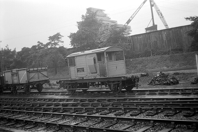 SR 20T (re-rated from 15T - slim solebars) unfitted 'Pillbox' brake van at the entrance to Horsham MPD. Agate timber yard to the rear - 1960s - unattrib., © Paul Kearley Steam Collection
